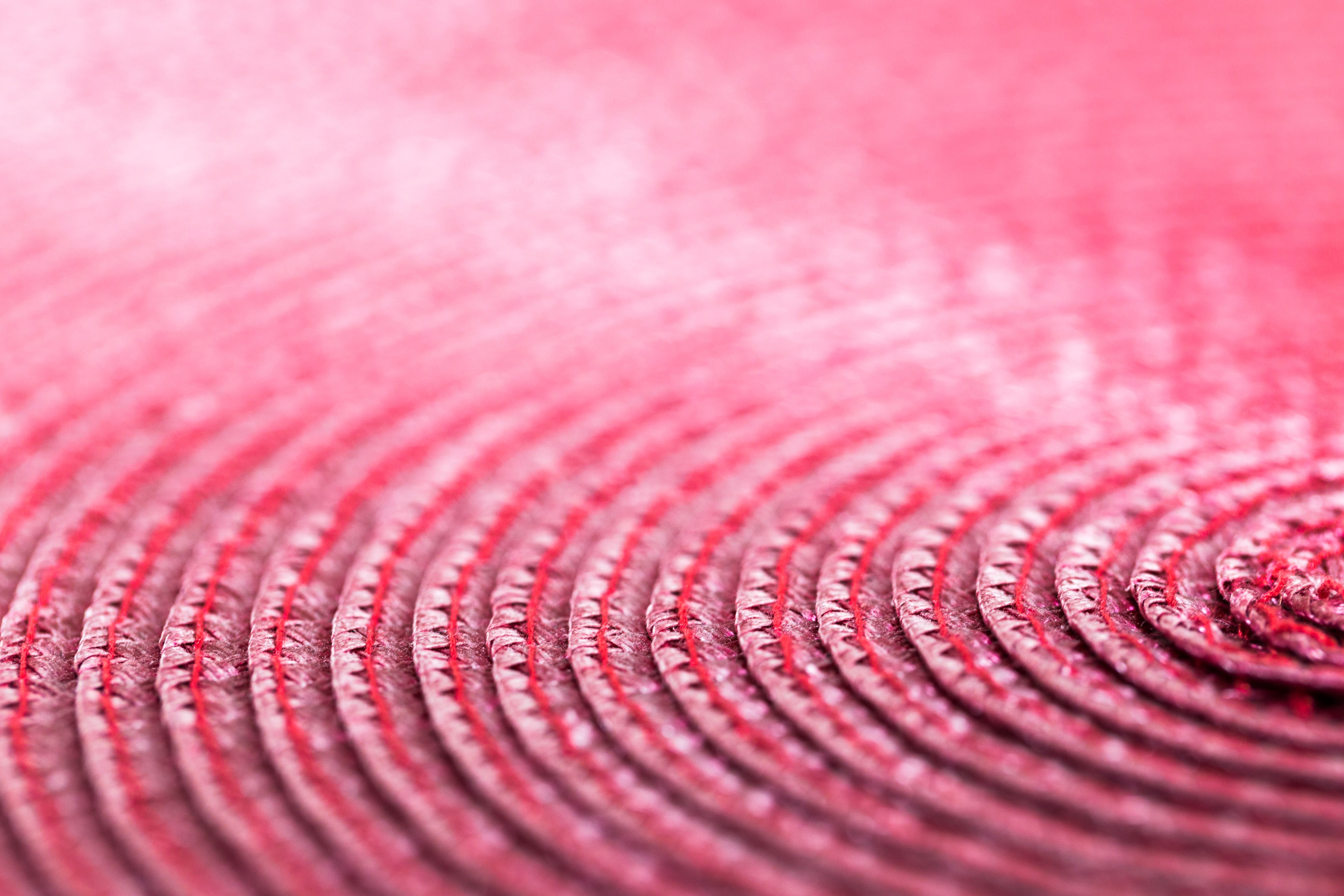 Closeup of a bright pink woven background with a clear space for text to be added