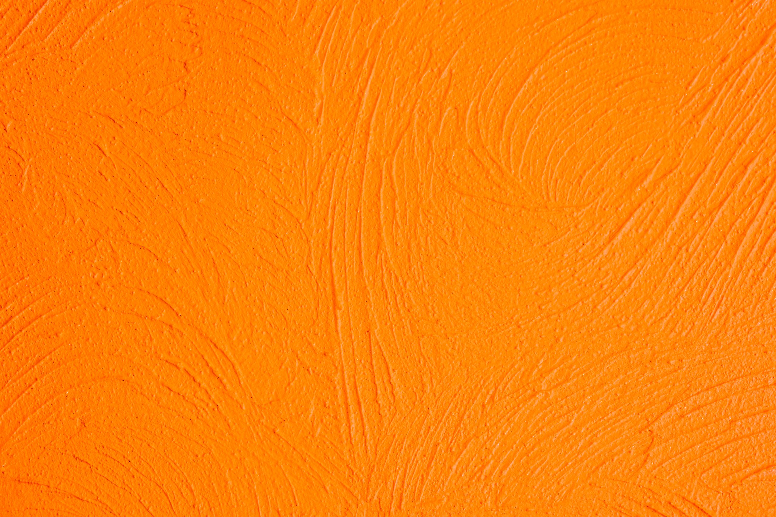 Textured orange surface with visible brush strokes.